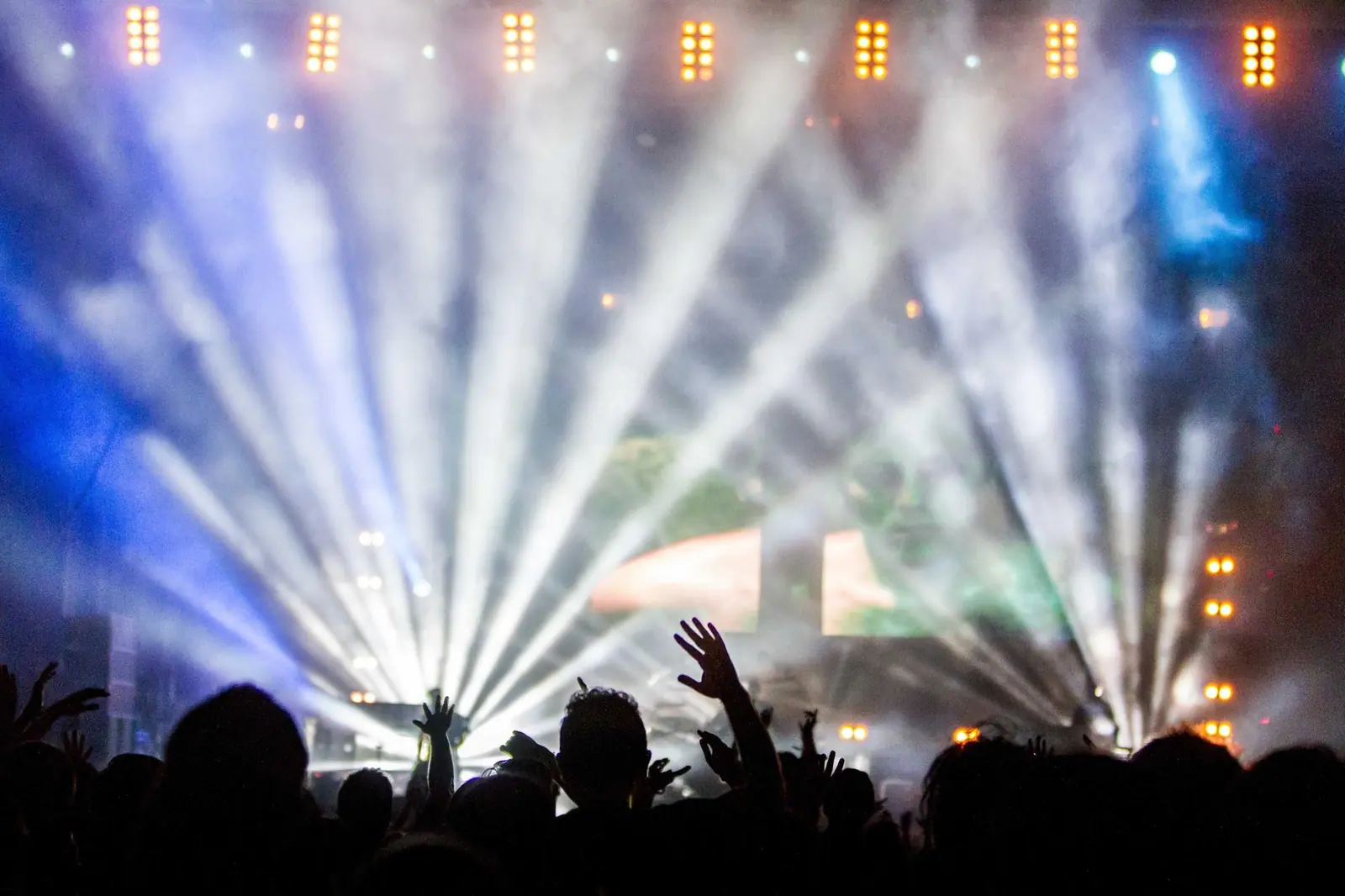 Stage lights over a crowd at a live event